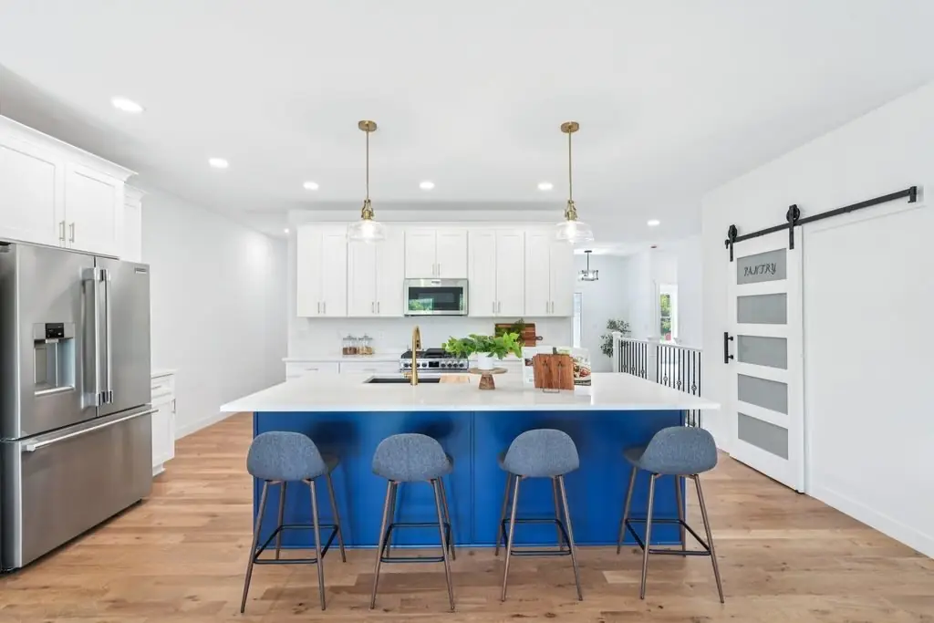Tess kitchen with navy island, by G&A Construction